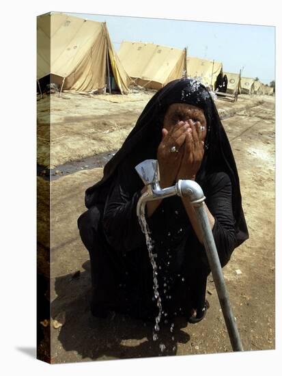 A Woman Washes Her Face with Water from a Tap at a Camp for Displaced Iraqis-null-Premier Image Canvas