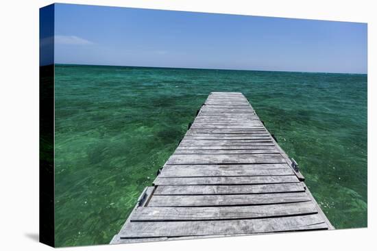 A Wood Dock in the Foreground with Clear Green Water and Blue Skies Near the Isle of Youth, Cuba-James White-Premier Image Canvas