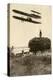 A Wright Airplane over a Hayfield in France, 1908, Flown by Wilbur Wright and a Pupil-null-Premier Image Canvas