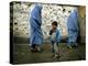 A Young Afghan Refugee Boy Stands in a Pair of Adult's Shoes-null-Premier Image Canvas