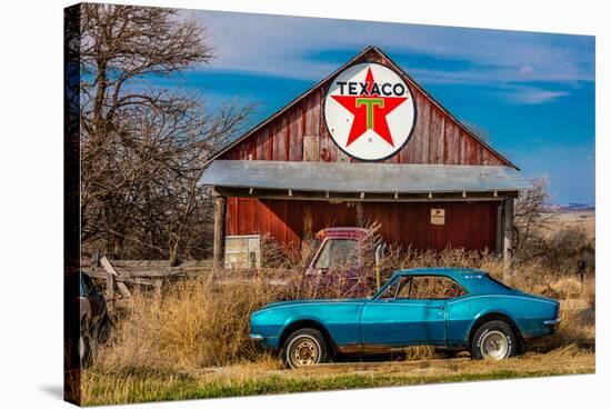 Abandoned blue Camaro Chevrolete in front of deserted Texaco Station, remote part of Nebraska-null-Stretched Canvas