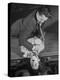 Actor Dramatizing the Realistic Stabbing Trick in Production at the Grand Guignol Theater-null-Premier Image Canvas