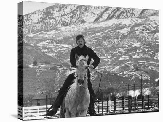 Actor Robert Redford Exercising One of His Eight Saddle Horses on His Remote Mountain Ranch-John Dominis-Premier Image Canvas