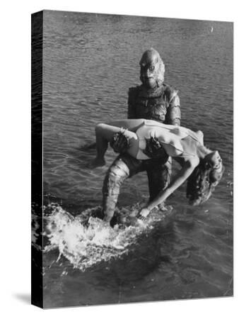Actress Julia Adams Is Carried By Monster Gill Man In The Movie Creature From The Black Lagoon Premium Photographic Print Ed Clark Art Com
