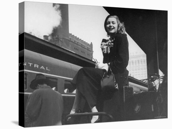 Actress Patricia Neal Sitting on Her Luggage on the Platform of a Train Station During a Stopover-Ed Clark-Premier Image Canvas
