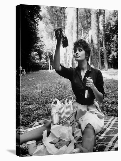 Actress Sophia Loren Examining Contents of Bottle During Location Filming of "Madame Sans Gene"-Alfred Eisenstaedt-Premier Image Canvas