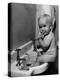 Adorable Baby Brushing Teeth While Sitting in Sink-null-Premier Image Canvas