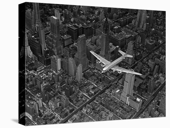 Aerial View of a DC-4 Passenger Plane Flying over Midtown Manhattan-Margaret Bourke-White-Premier Image Canvas