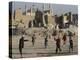 Afghan Boys Play Soccer Near a Mosque and Ruined Buildings During the Early Morning-null-Premier Image Canvas