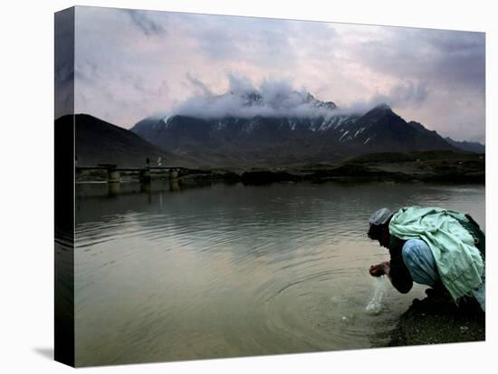 Afghan Man Washes His Face in the River before Going to Evening Prayers-null-Premier Image Canvas