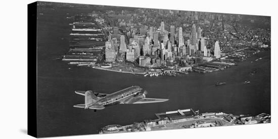 Airplane flying towards Manhattan-null-Stretched Canvas