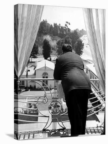 Alfred Hitchcock on Balcony Railing of Apartment, Looking Out over Grounds of Wilshire Palms-Peter Stackpole-Premier Image Canvas