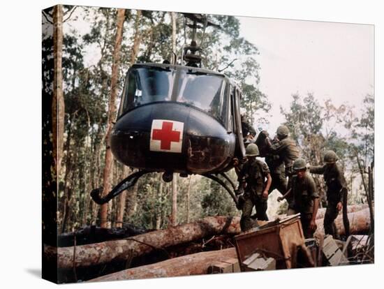 American 4th Battalion, 173rd Airborne Brigade Soldiers Loading Wounded Onto a "Huey" Helicopter-Alfred Batungbacal-Premier Image Canvas
