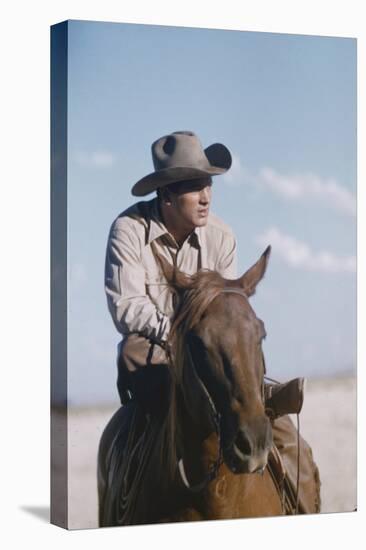 American Actor Rock Hudson on a Horse During the Filming of 'Giant', Near Marfa, Texas, 1955-Allan Grant-Premier Image Canvas