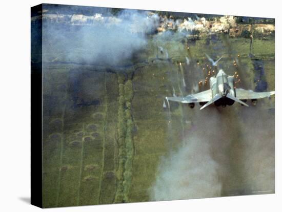 American F4C Phantom Jet Firing Rockets into Viet Cong Stronghold village During the Vietnam War-Larry Burrows-Premier Image Canvas
