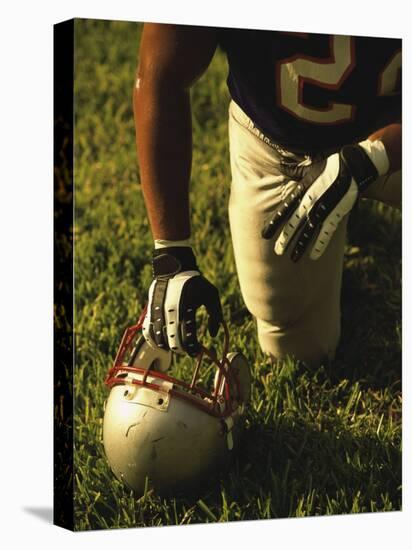 American Football Player Kneeling on the Field-null-Premier Image Canvas