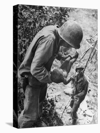 American Lieutenant Carrying Micronesian Baby He Found in cave Japanese Soldiers Holed Up There-W^ Eugene Smith-Premier Image Canvas