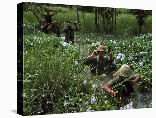 American Soldiers Wade Through Marshy Area During the Vietnam War-Paul Schutzer-Premier Image Canvas