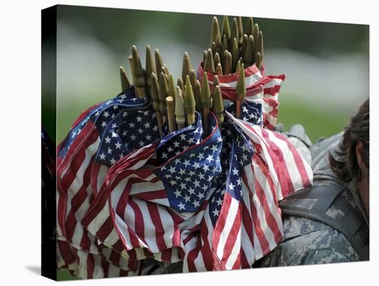 An Army Soldier's Backpack Overflows with Small American Flags-Stocktrek Images-Premier Image Canvas