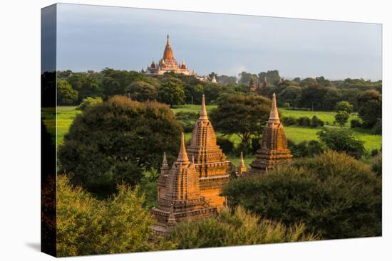 Ancient temple and pagoda rising out of the jungle at sunrise, Bagan, Mandalay Region, Myanmar-Keren Su-Premier Image Canvas