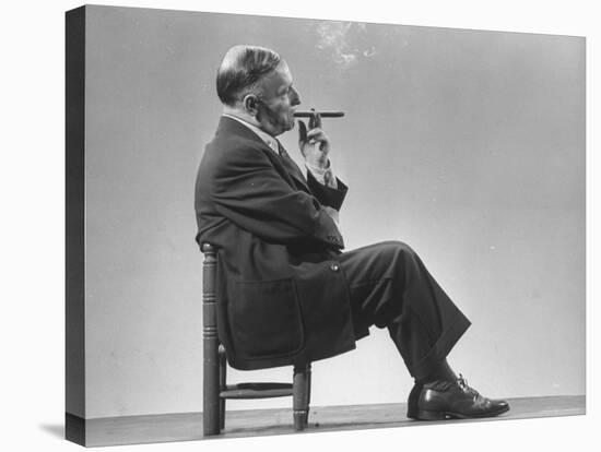 Architect Frederick Kiesler Seated in a Child's Chair, Smoking a Cigar, at Gjon Mili's Studio-Gjon Mili-Premier Image Canvas