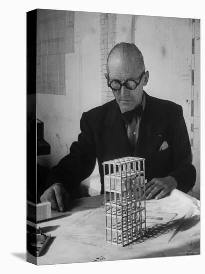 Architect Le Corbusier Studying Architectural Plans and Small Model of Building in His Office-Nina Leen-Premier Image Canvas