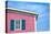 Architecture Detail of a Pink House with Blue Shuttered Window against Blue Sky-pink candy-Premier Image Canvas