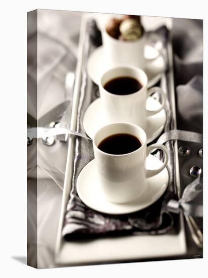 Arrangement of Two Cups of Coffee and Chocolates-Joff Lee-Premier Image Canvas