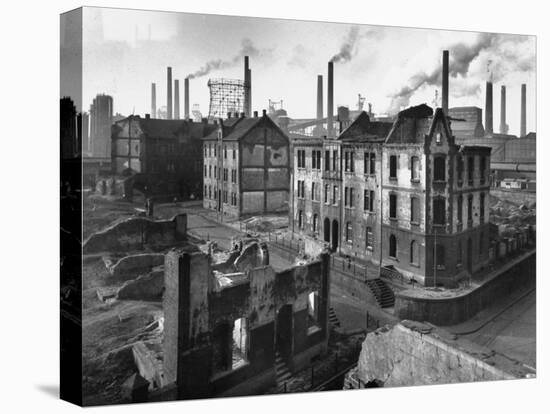 August Thyssen Steel Mill, Large Steel Works, Looming Smokily Behind Bomb-Ruined Town-Ralph Crane-Premier Image Canvas