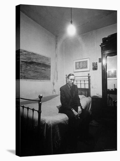 Author William Burroughs, an Ex Dope Addict, Relaxing on a Shabby Bed in a "Beat Hotel"-Loomis Dean-Premier Image Canvas