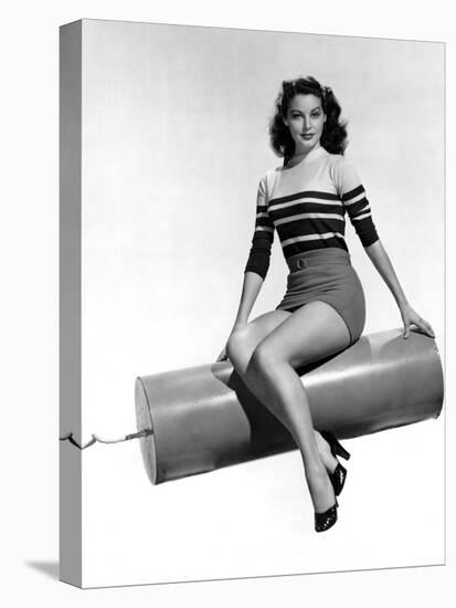 Ava Gardner seated on Giant firecracker, c. 1945 (b/w photo)-null-Stretched Canvas