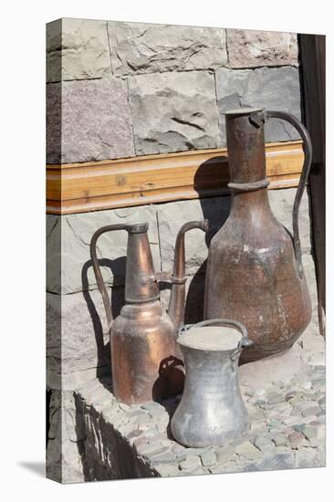 Azerbaijan, Lahic. A copper kettle and jug sitting outside a residence.-Alida Latham-Premier Image Canvas