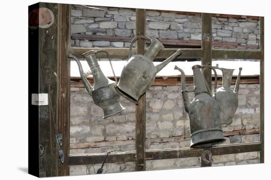 Azerbaijan, Lahic. Antique kettles hanging on the inside of a window.-Alida Latham-Premier Image Canvas