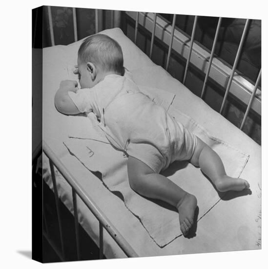 Baby Sleeping on its Stomach in Nursery at St. Vincent's Hospital-Nina Leen-Premier Image Canvas
