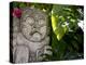 Bali, Ubud, a Stone Carving, Adorned with a Hibiscus Flower, Sits in Tropical Gardens-Niels Van Gijn-Premier Image Canvas