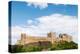 Bamburgh Castle, a fortress constructed on top of a craggy outcrop of volcanic dolerite-Stuart Forster-Premier Image Canvas