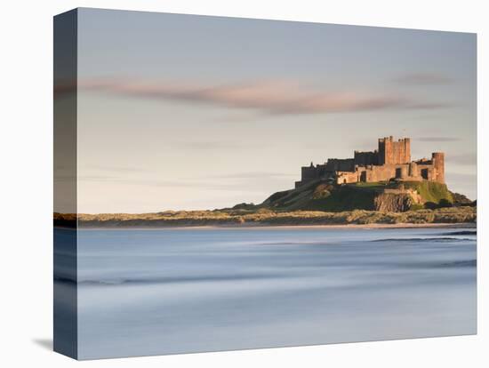 Bamburgh Castle Bathed in Golden Evening Light Overlooking Bamburgh Bay with the Sea Filling the Fo-Lee Frost-Premier Image Canvas