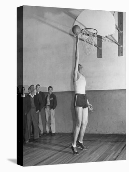 Basketball Player Max Palmer Reaching Up to Drop Basketball into Basket-null-Premier Image Canvas