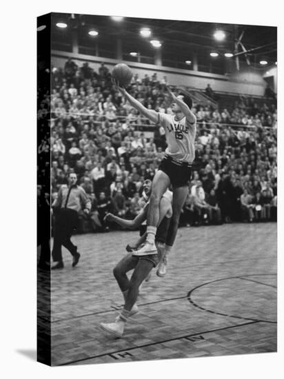 Basketball Player Tom Gola Leaping in the Air to Make a Shot During a Basketball Game-null-Premier Image Canvas