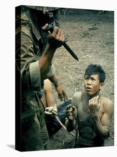 Bayonet Wielding South Vietnamese Soldier Menacing Captured Viet Cong Suspect During Interrogation-Larry Burrows-Premier Image Canvas