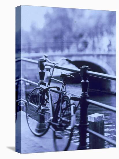 Bicycle on Rail by Canal, Amsterdam, Netherlands-Walter Bibikow-Premier Image Canvas