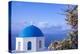 Blue domed Greek Orthodox church with bougainvillea flowers in Oia, Santorini, Greece.-Michele Niles-Premier Image Canvas