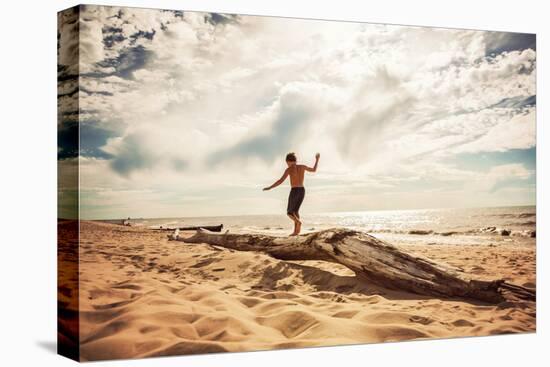 Boy Balancing on a Washed up Tree Trunk on the Beach-soupstock-Premier Image Canvas