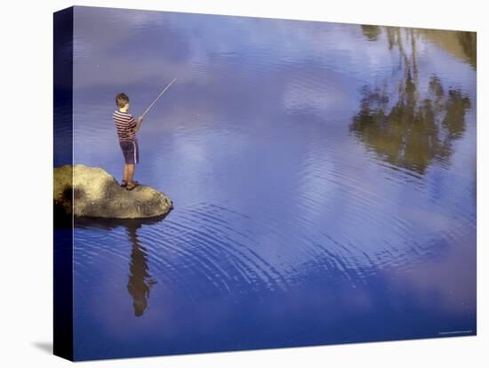 Boy Fishing from a Rock on a Pond-null-Premier Image Canvas