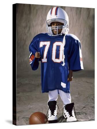 'Boy in an Oversized Football Uniform Wearing a Helmet' Photographic