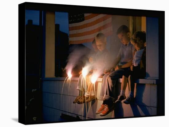 Boys Sitting on Porch Holding Sparklers, with US Flag in Back, During Independence Day Celebration-Nat Farbman-Premier Image Canvas