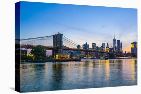 Brooklyn Bridge and Manhattan skyline at dusk, viewed from the East River, New York City, United St-Fraser Hall-Premier Image Canvas