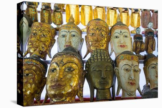 Buddha masks on display at shop, Mandalay, Myanmar (Burma)-Jan Miracky-Premier Image Canvas