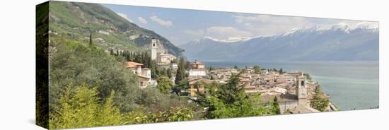 Buildings at the Waterfront with Snowcapped Mountain in the Background, Gargnano, Monte Baldo-null-Stretched Canvas