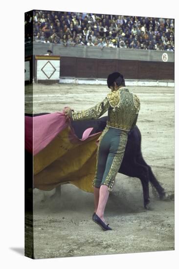 Bullfighter Manuel Benitez, Known as "El Cordobes," Sweeping His Cape Aside the Charging Bull-Loomis Dean-Premier Image Canvas